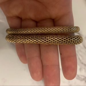 Multiple gold bracelets